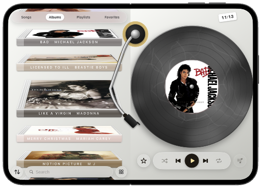 iPhone Duo open flat, albums beside a vinyl record.