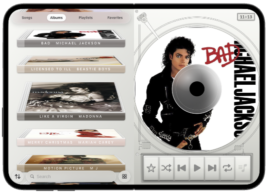 iPhone Duo open flat, albums beside the disc.